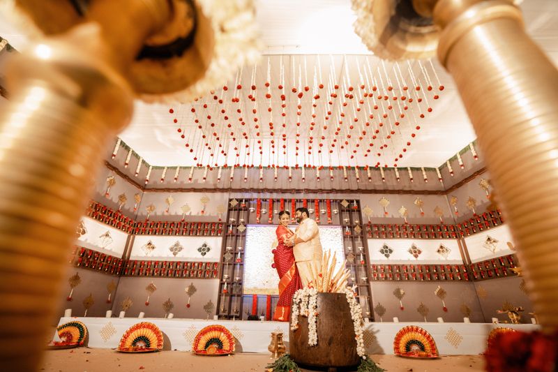 Wedding venue with geometric ceiling design, ornate patterns, and warm lighting creating a stunning architectural frame.