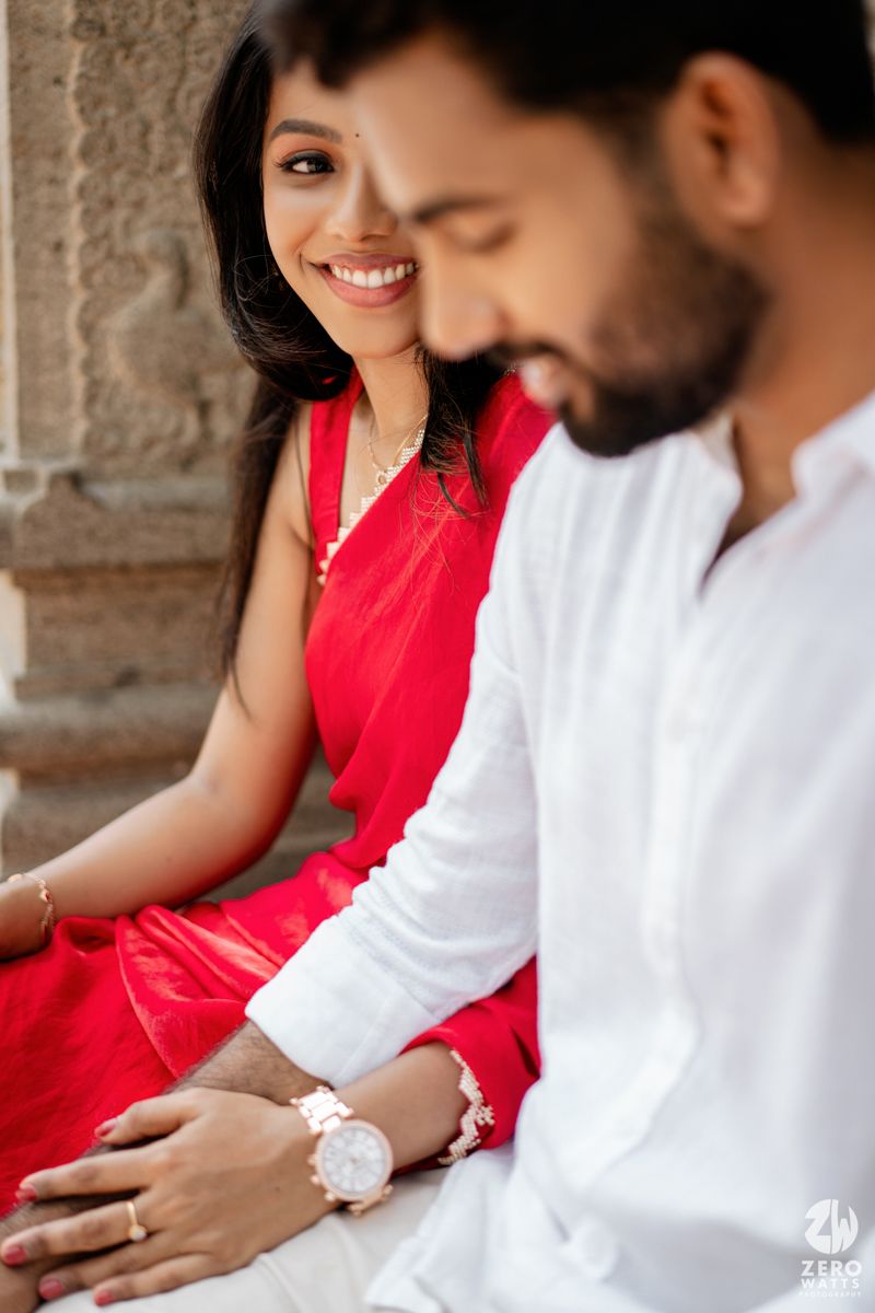 Series of intimate moments captured between couple in red sari and white outfit sitting together.