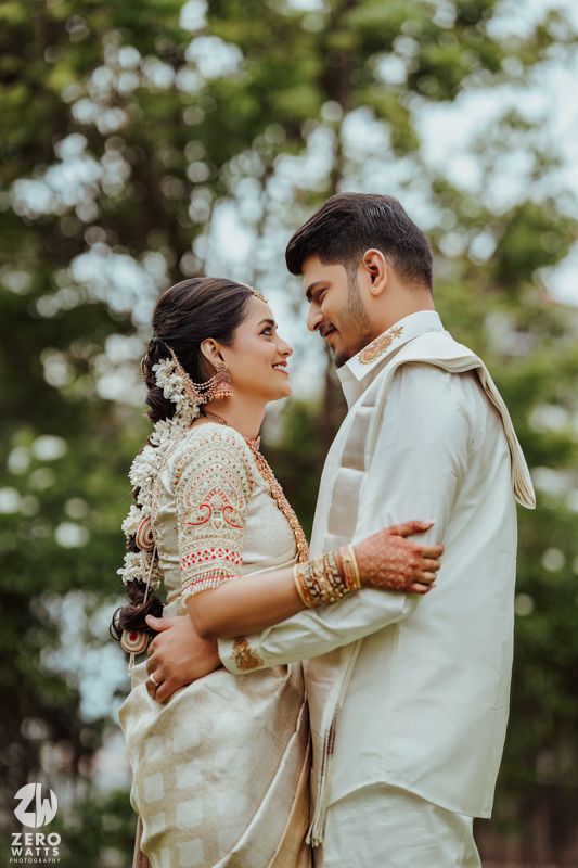 Intimate romantic moment captured between couple in traditional wedding attire.