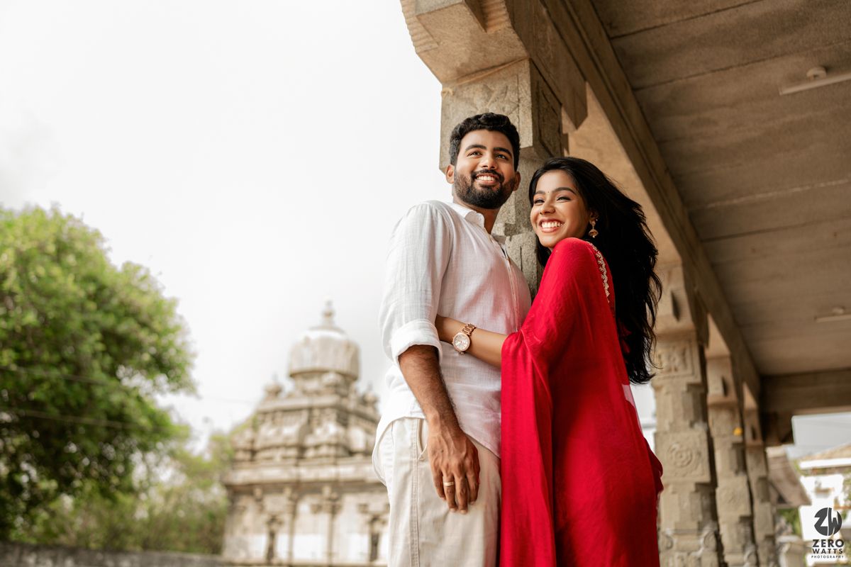 Romantic photo series showing couple in red and white enjoying moments in historic architecture.