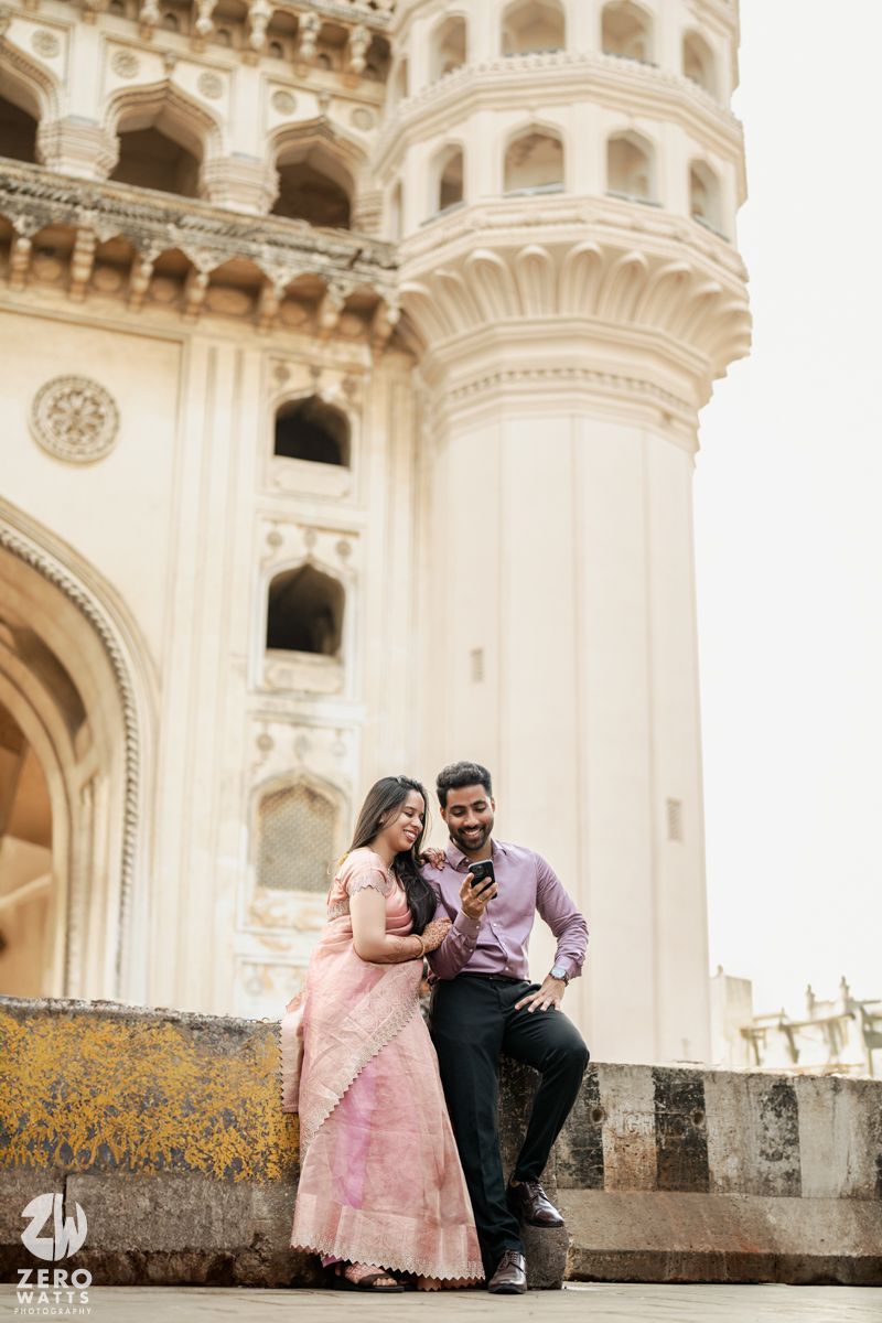 Romantic photoshoot at historic Charminar monument with ornate architecture.