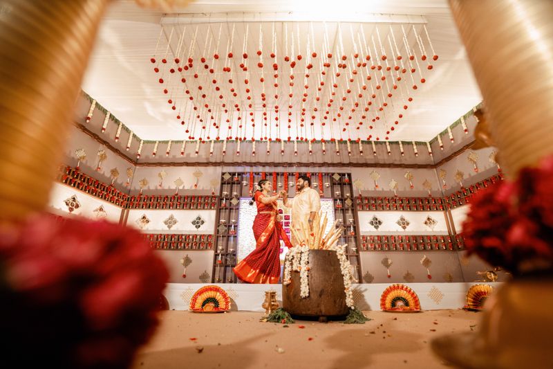 Wedding venue decorated with hanging red hearts and traditional ornaments creating a romantic atmosphere.