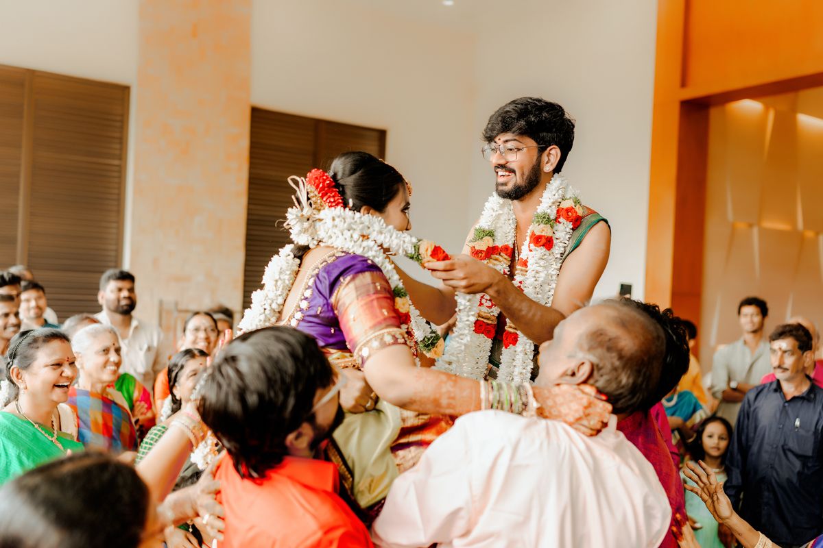 A festive gathering showing traditional Indian wedding rituals with celebratory crowd.