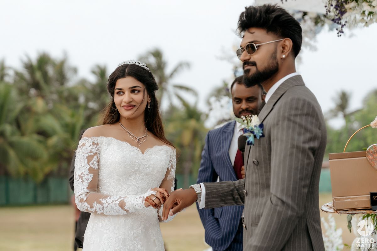 Elegant wedding couple sharing a special moment in a tropical outdoor setting.