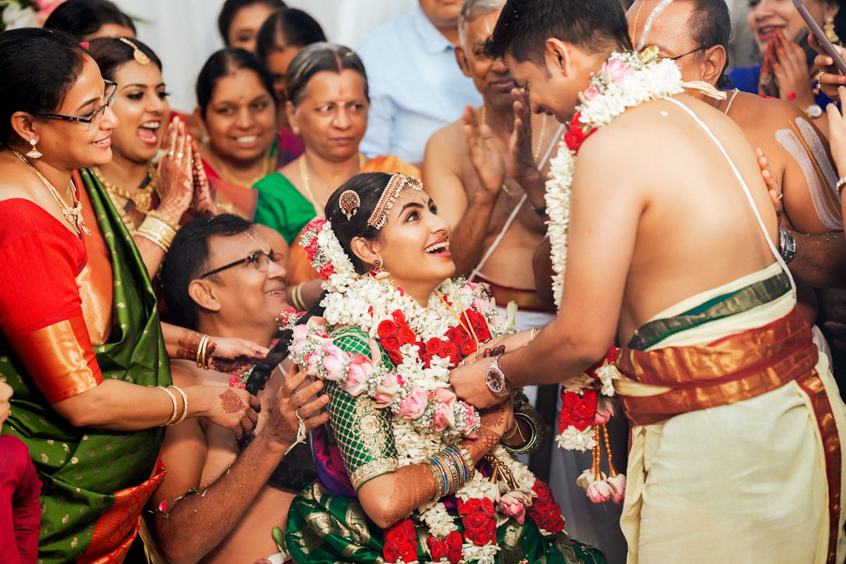 Traditional South Indian wedding ceremony with family gathered around during an intimate ritual moment.