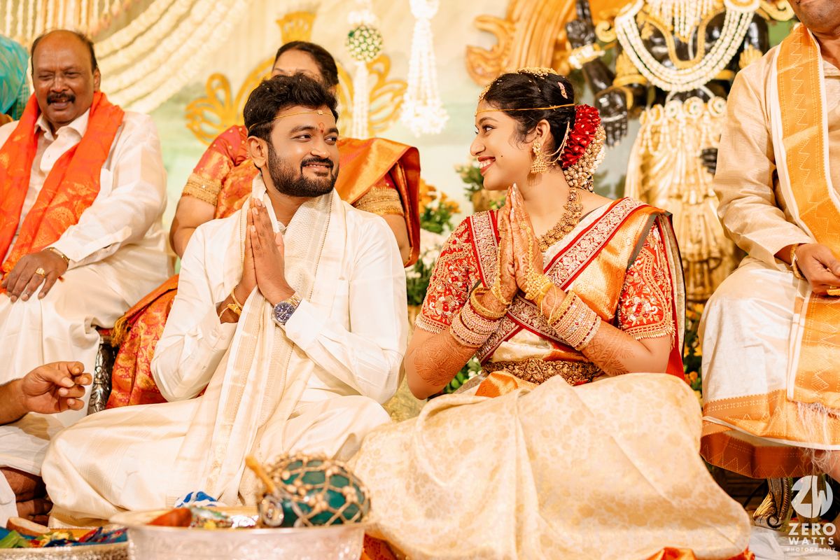 Wedding ritual being performed as guests gather around during traditional South Indian ceremony.
