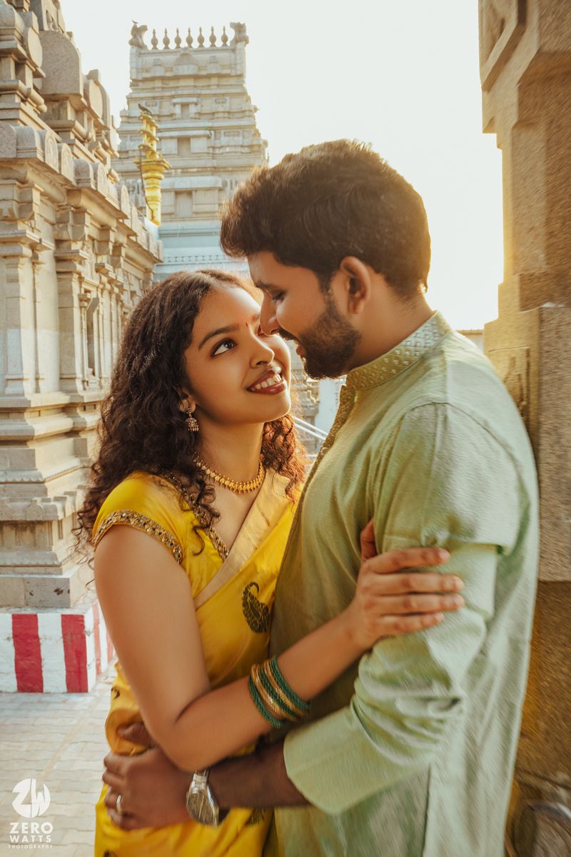A romantic sunset moment captured at a traditional South Indian temple with intricate architecture.