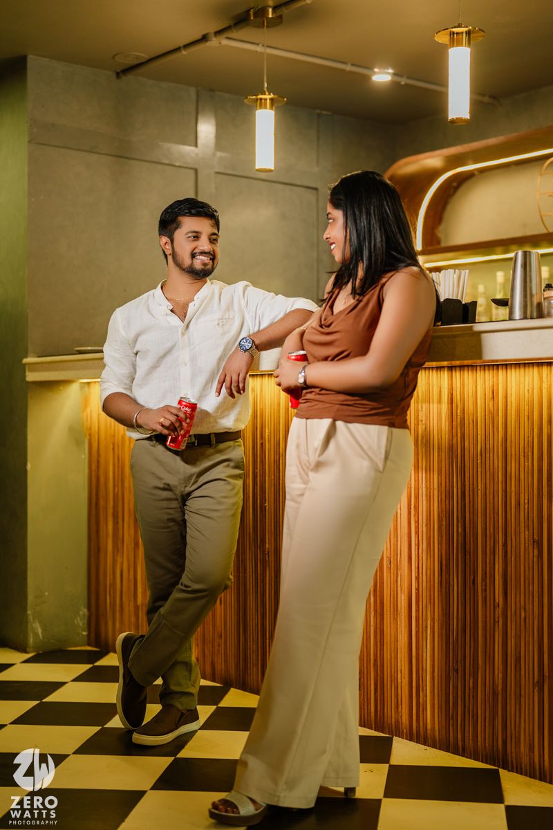 Casual conversation in a stylish restaurant with wood paneling and checkerboard flooring.