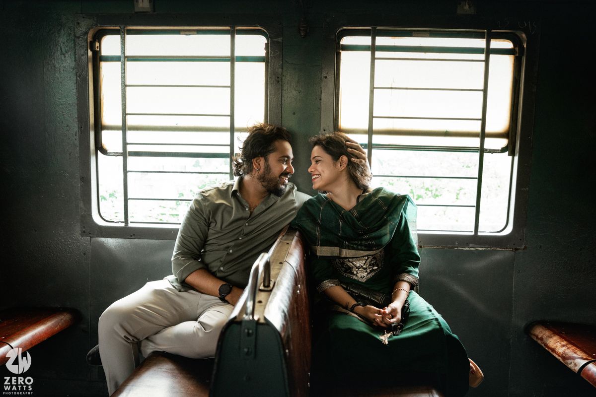 Sweet interaction between two people sharing a moment on a train seat.