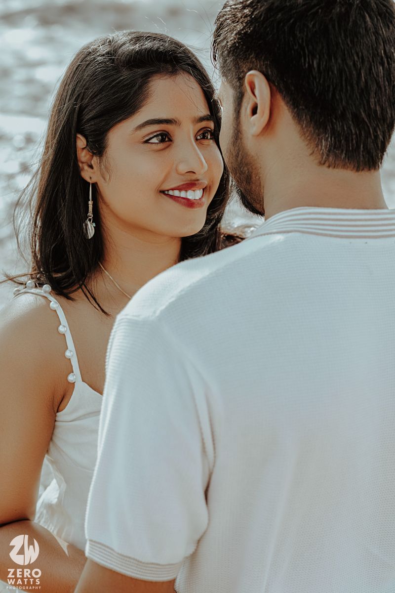 A close-up romantic moment captured at the beach with soft natural lighting.