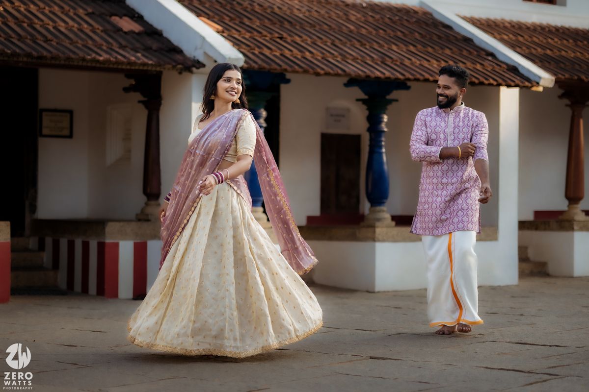 Traditional Indian courtyard with someone in an elegant cream and pink lehenga.