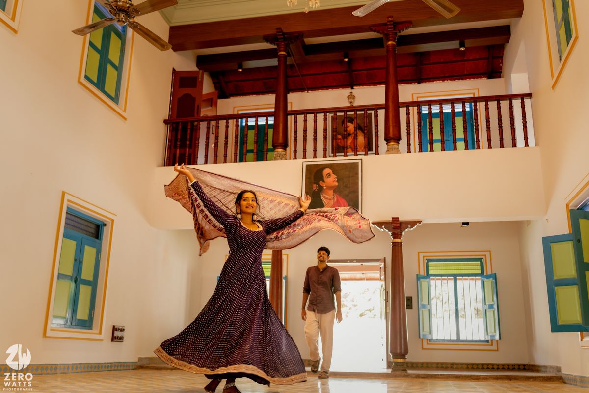 A joyful dance moment captured in a traditional interior space with colorful wooden accents and bright windows.