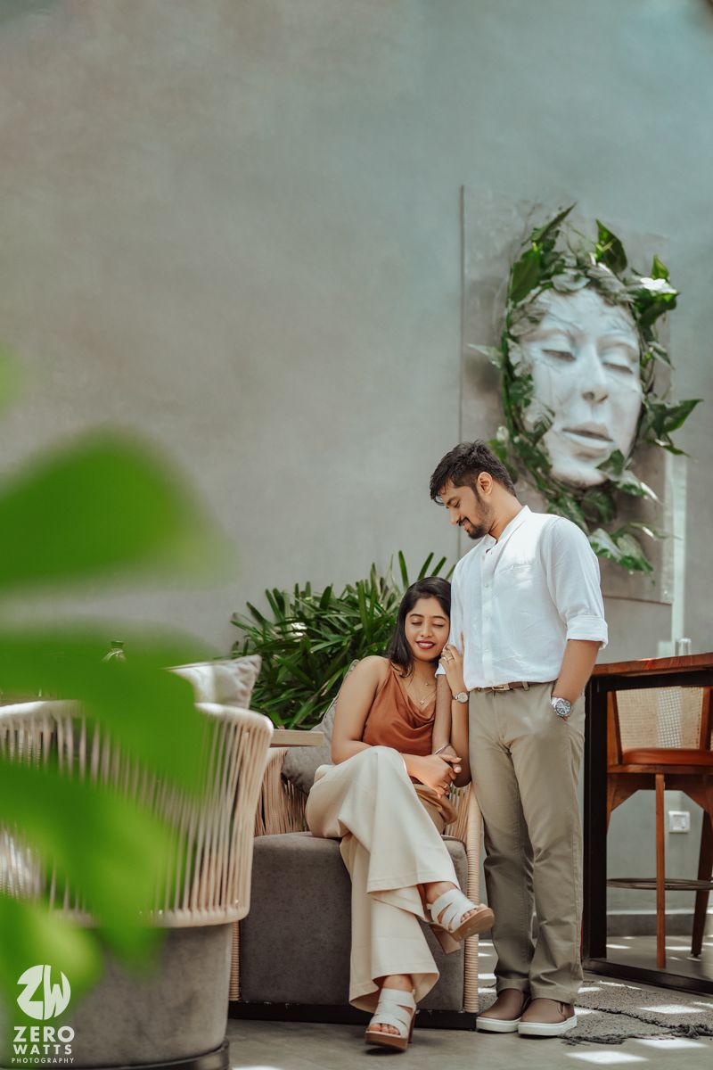 Casual lifestyle photoshoot of couple relaxing on modern furniture in indoor setting.