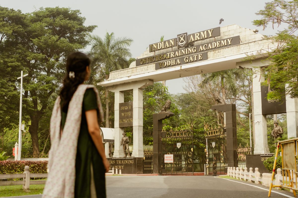 University entrance gate with palm trees and archway sign visible in warm vintage tones.