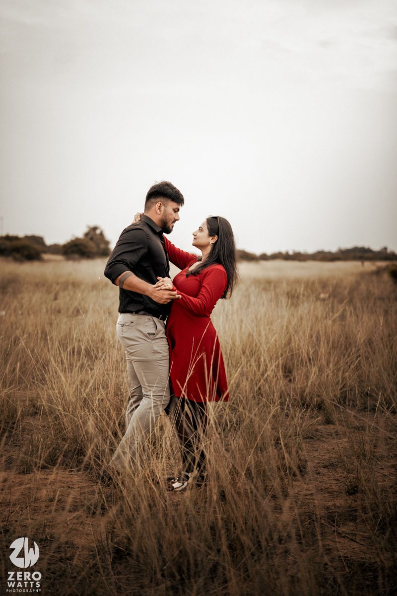A romantic dance sequence in tall grass with sepia tones.