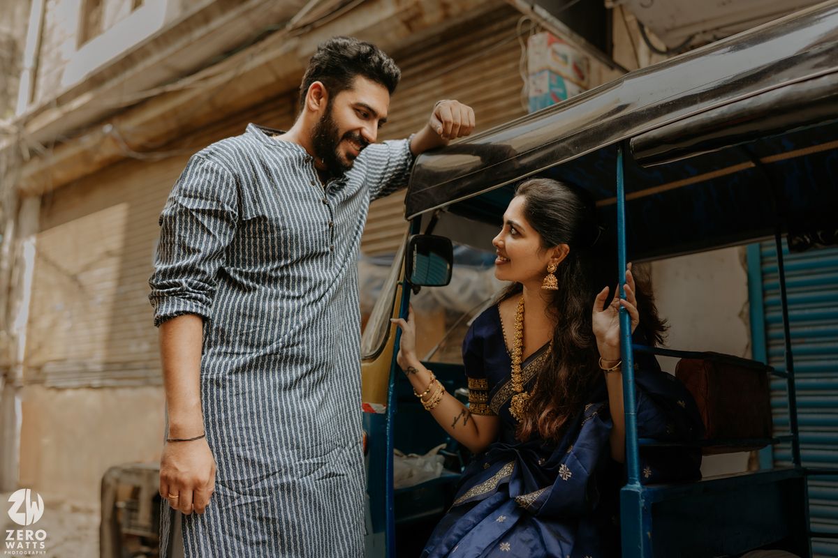 Two people sharing a happy conversation on an urban street in front of a building.