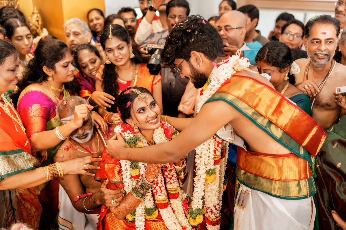 Traditional South Indian wedding ceremony with guests gathered around during an auspicious ritual moment.