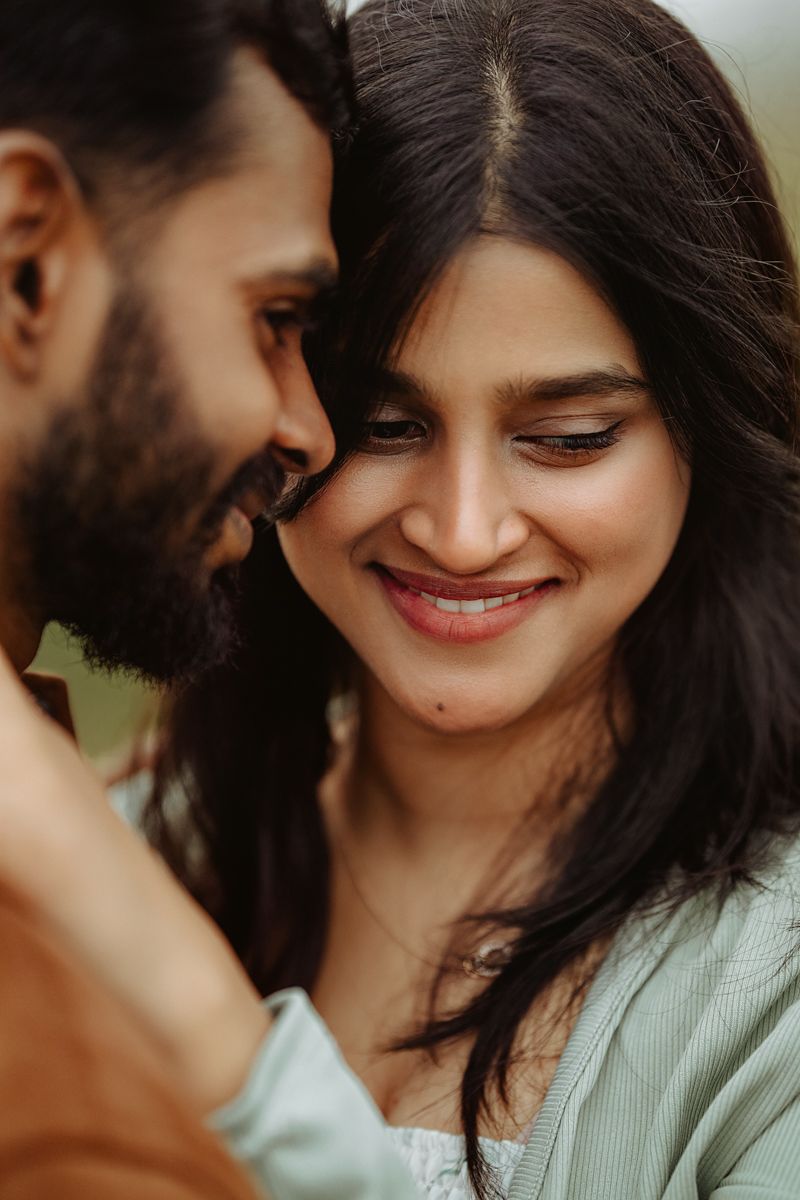 Intimate close-up of couple sharing a tender moment outdoors.