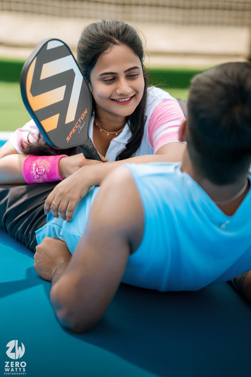 A candid moment of relaxation on a blue yoga mat with a pink sports shoe visible.