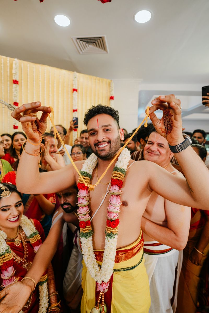 Traditional South Indian wedding ceremony with celebratory atmosphere and festive decorations.