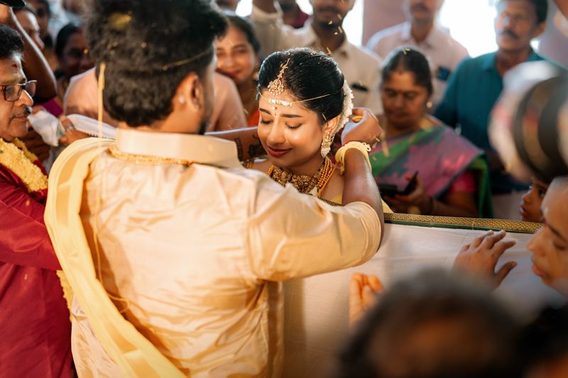 Traditional South Indian wedding ceremony with participants in traditional attire gathering for cultural rituals.