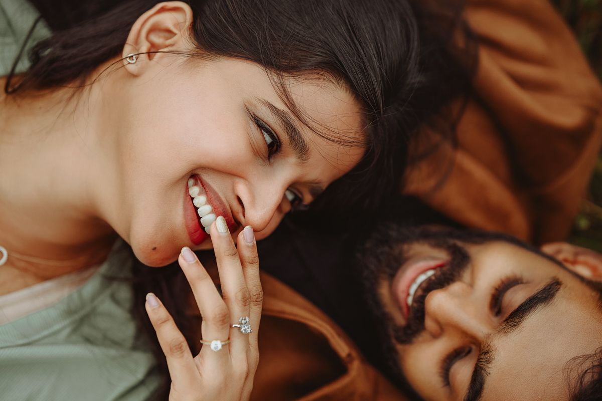 Close-up shot of a couple lying down and sharing a joyful moment together.