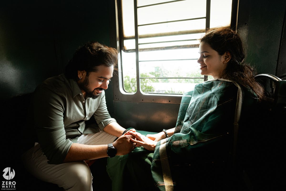 A romantic train journey scene with two people sitting close together in moody lighting.