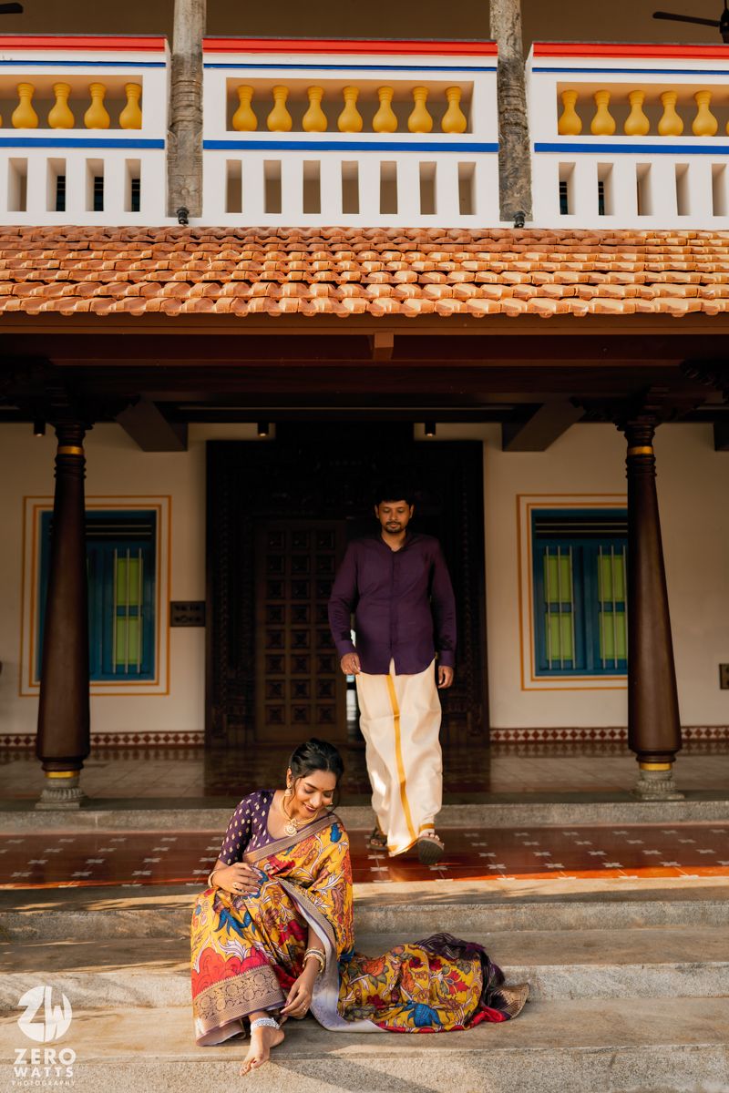 A traditional South Indian home with ornate architecture and pillars on the porch.