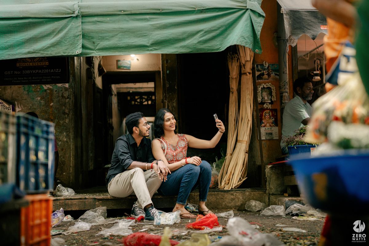 A casual moment captured under a green awning at a rustic market stall.