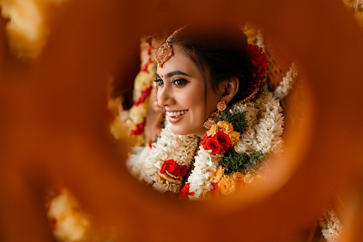 Traditional Indian bridal jewelry and decorations framed through circular floral arrangement.
