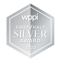 A row of five silver hexagonal award badges with text arranged horizontally against a black background.