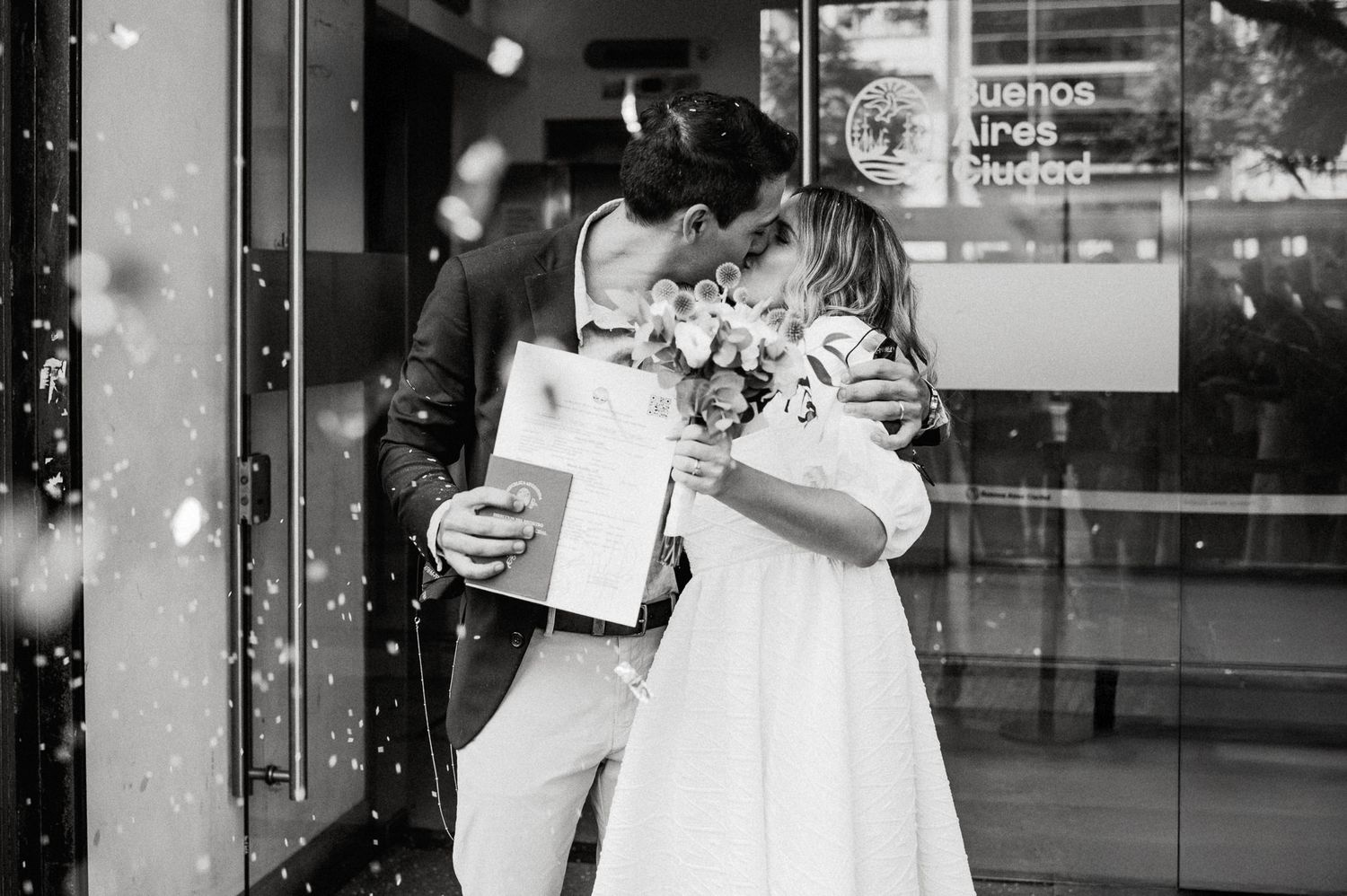 Couple celebrates romantic Starbucks date with coffee and affectionate moment in front of store window.