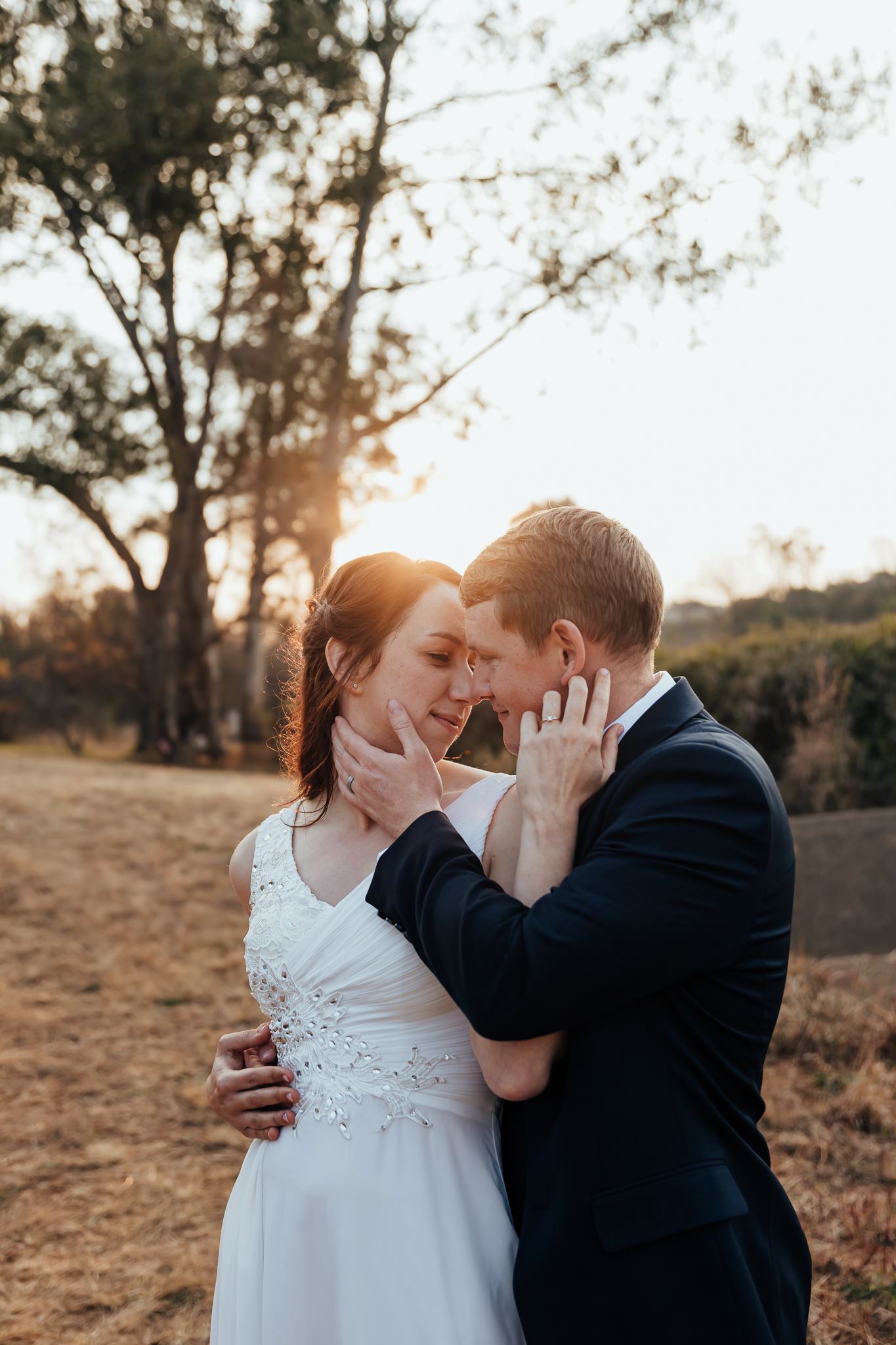 Intimate moment captured during golden hour in rustic outdoor setting.