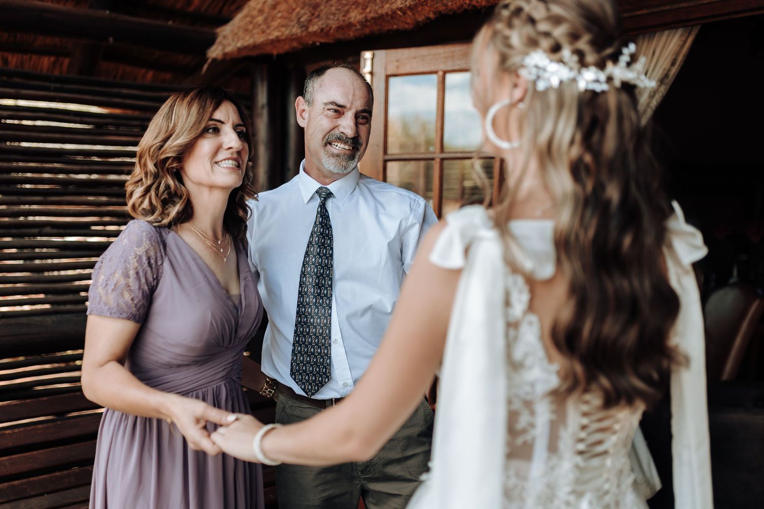 Wedding day gathering in rustic barn venue with warm lighting and wooden details.