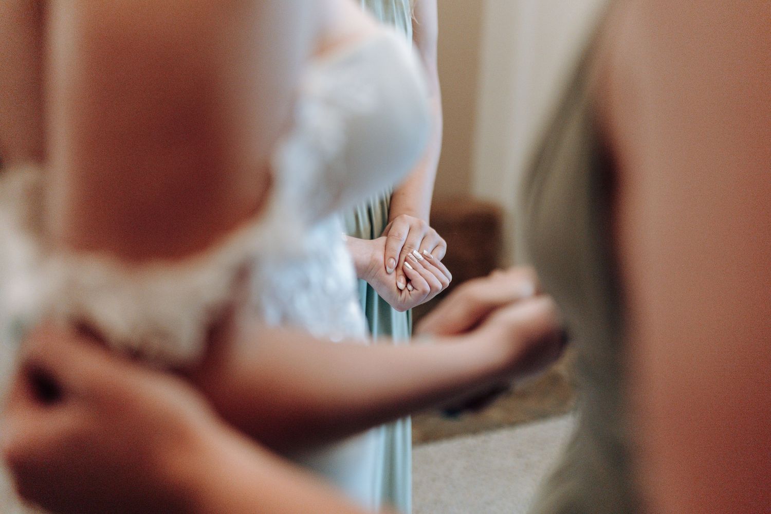 Close-up detail shot of wedding ring and hands during ceremony preparations.