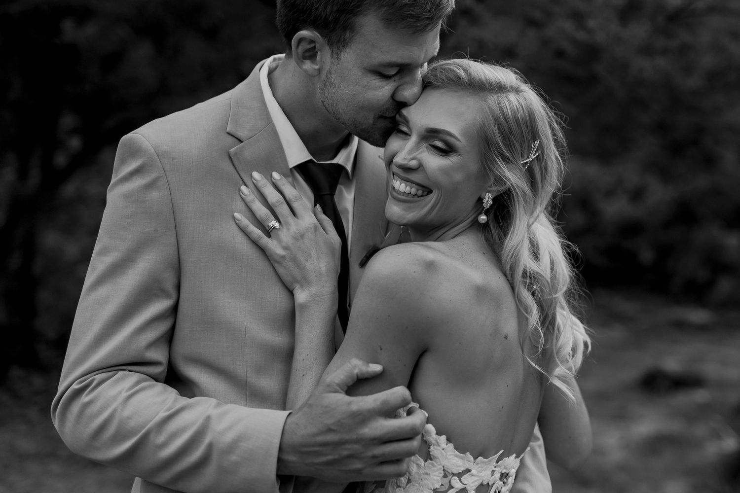 Black and white intimate wedding portrait showcasing joy and elegance.