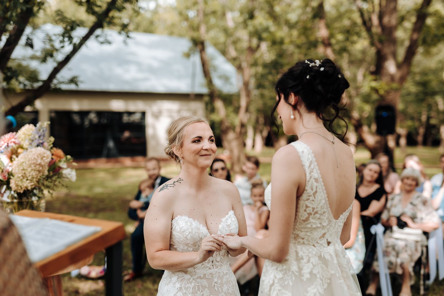 Emotional wedding ceremony moment in an outdoor garden setting.