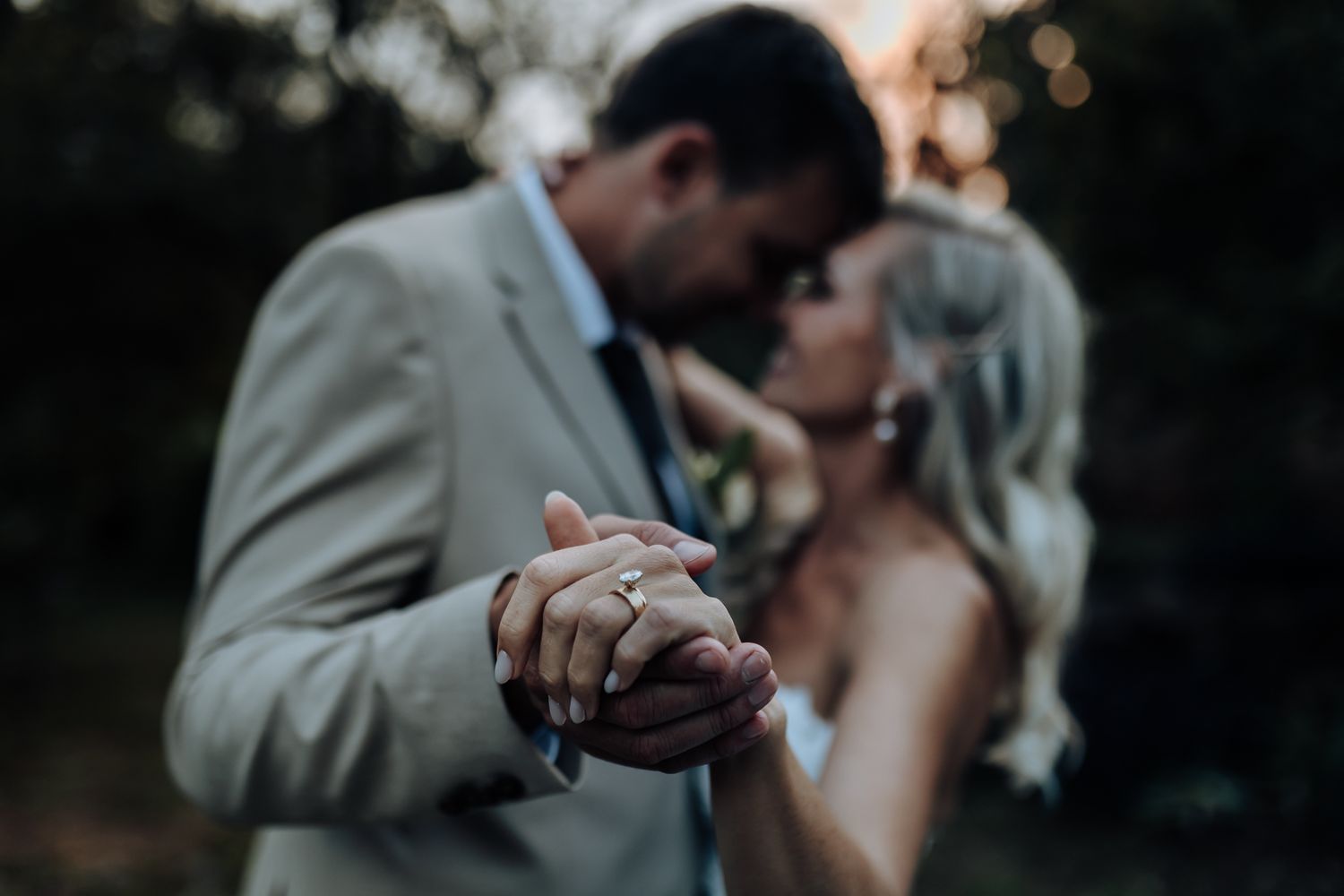 Intimate dancing moment captured during wedding celebration at dusk.