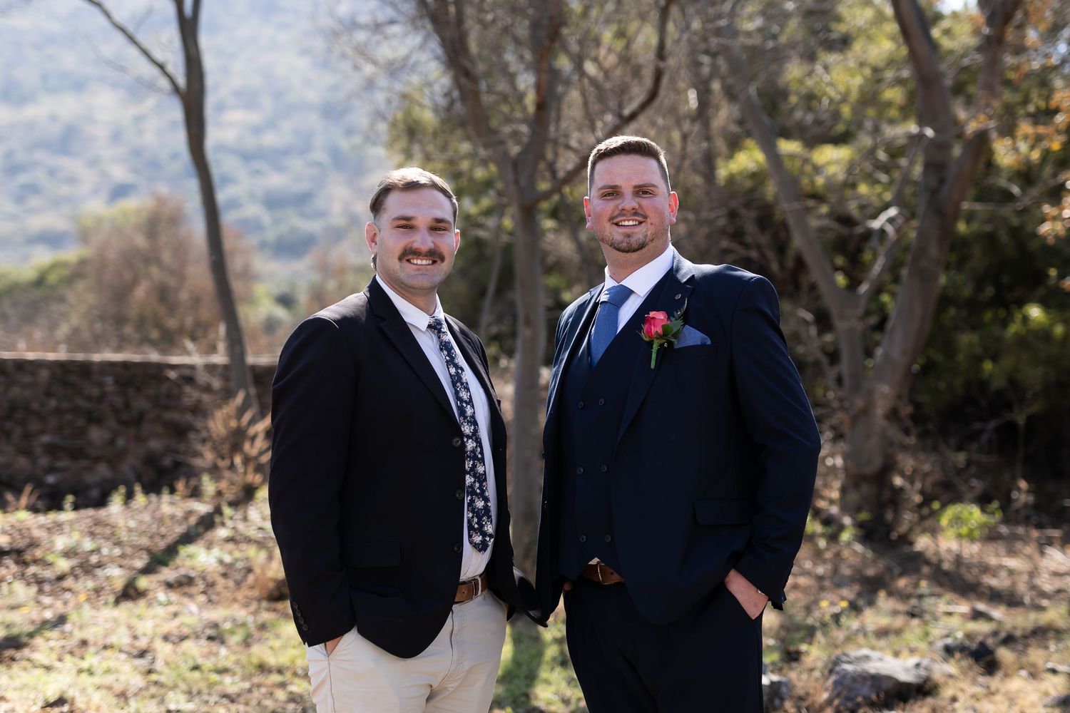 A series of six photos showing two people in dark suits smiling together outdoors against a natural backdrop.