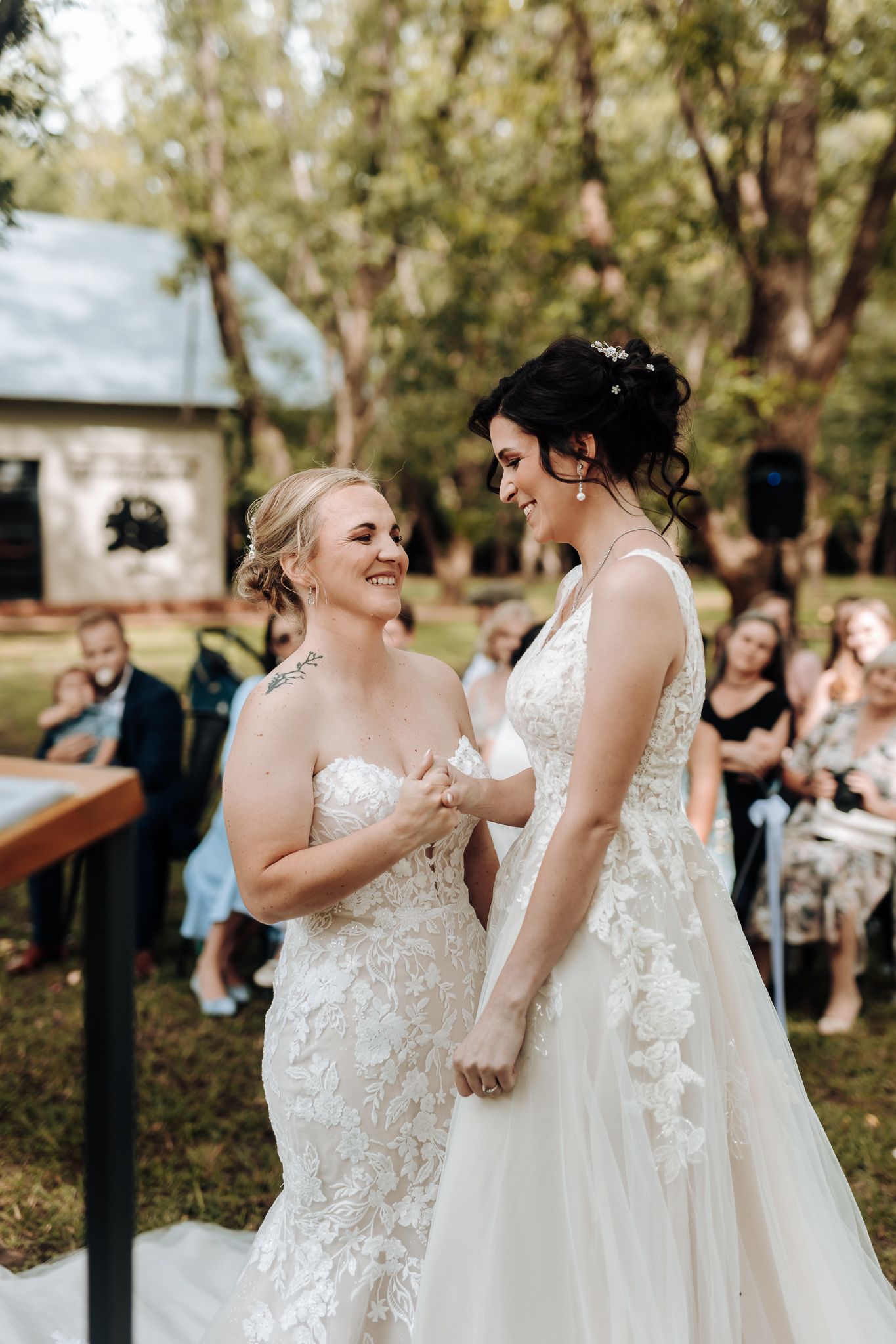 Joyful wedding ceremony moment outdoors with rustic barn in background.