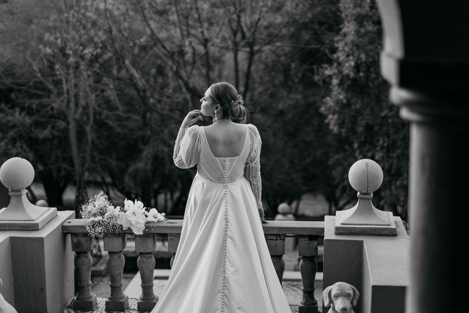 Black and white photo of bridal gown with architectural details and columns.