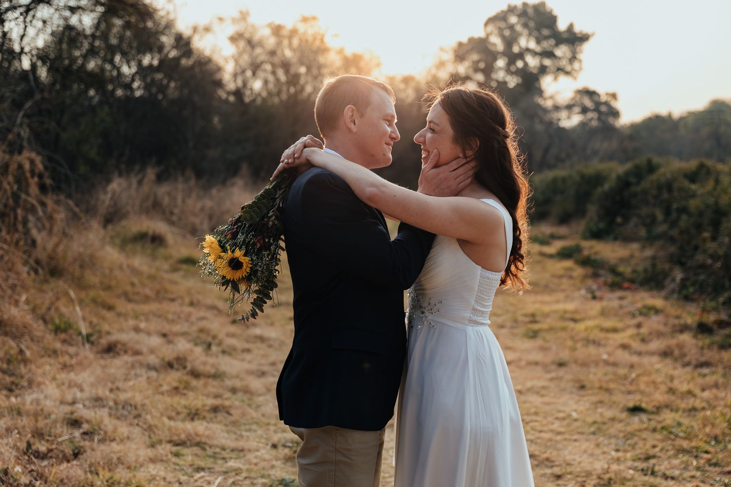 Romantic sunset photoshoot in a rustic field with natural lighting.