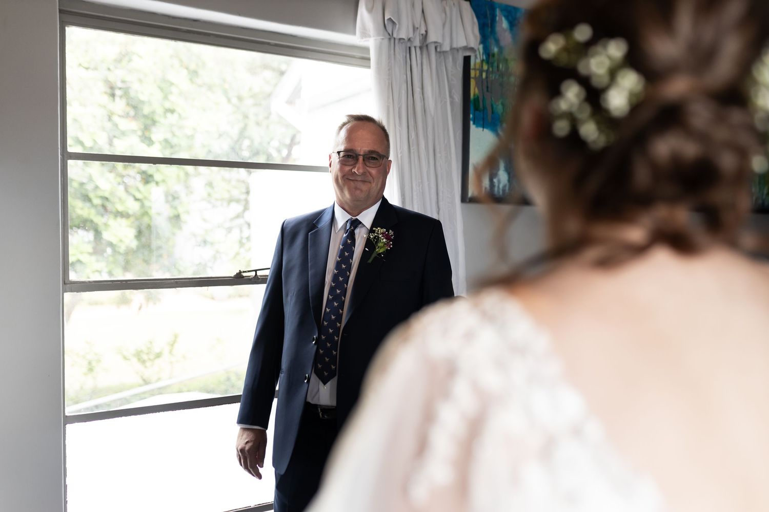An emotional pre-wedding moment captured near a bright window.