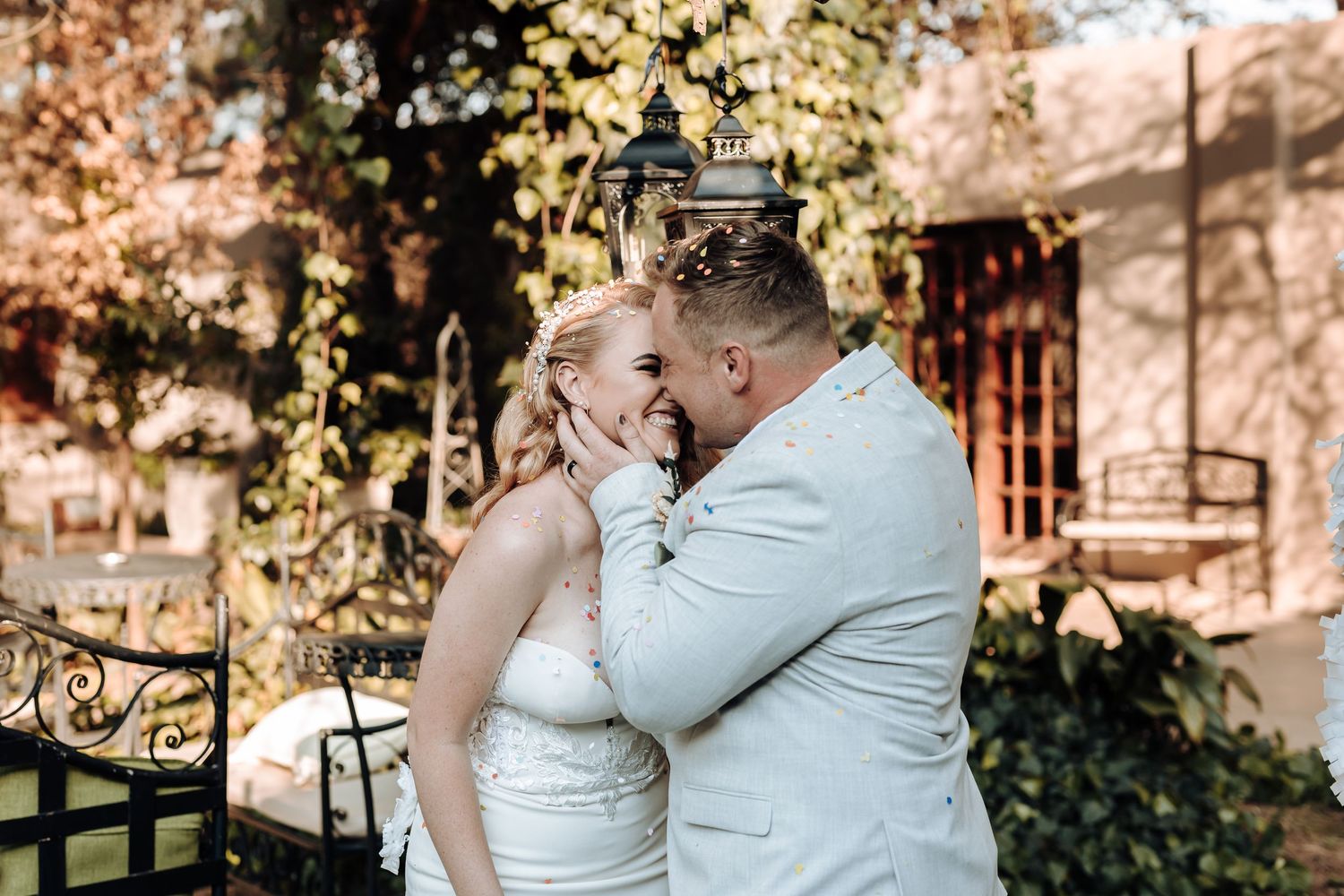Wedding couple embracing outdoors in an intimate romantic moment.