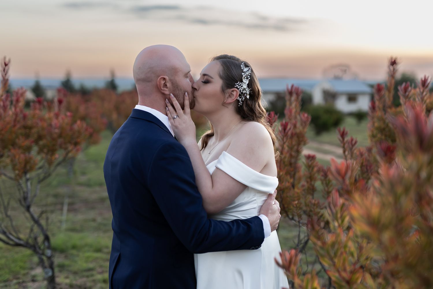 Romantic sunset moment between newlyweds surrounded by autumn foliage.