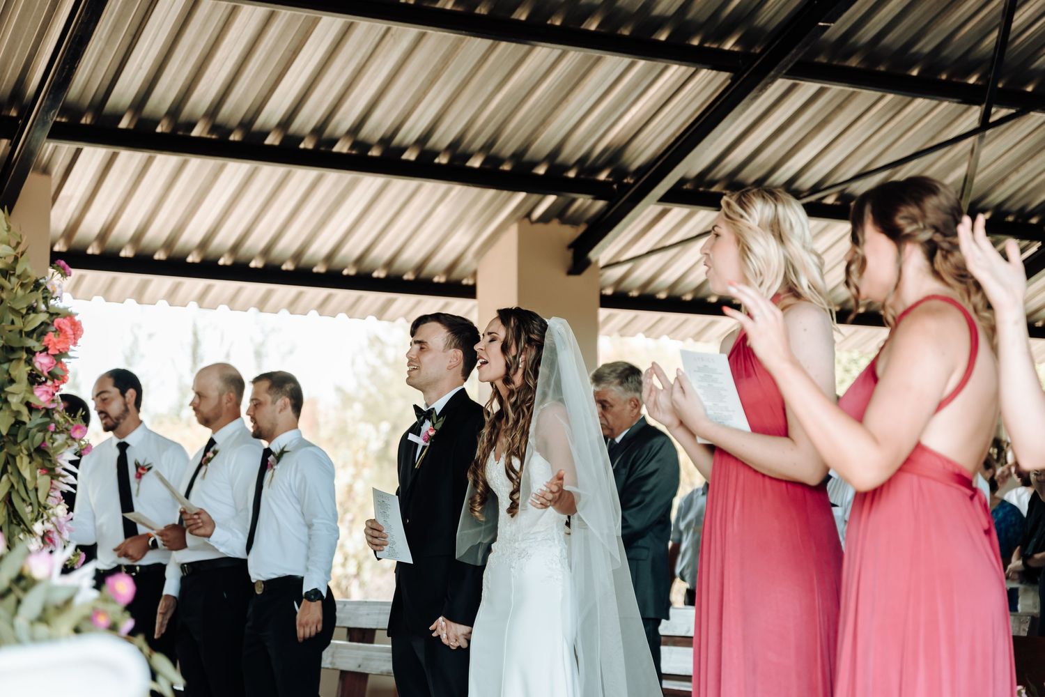 Wedding ceremony in progress with musicians and guests in casual attire.
