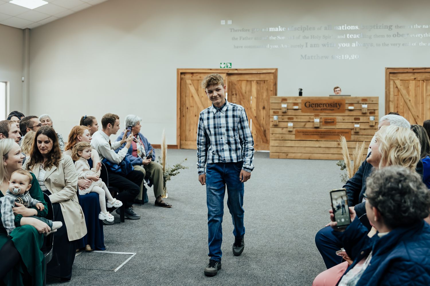 Group of people seated in rows at an indoor community or church gathering event.