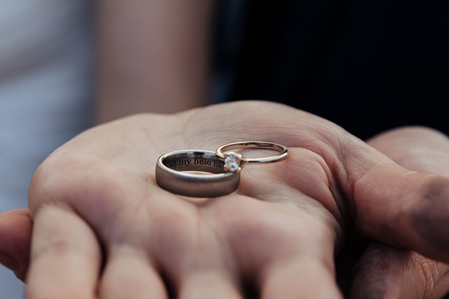 Close-up shot of wedding rings displayed on soft fabric with shallow depth of field.
