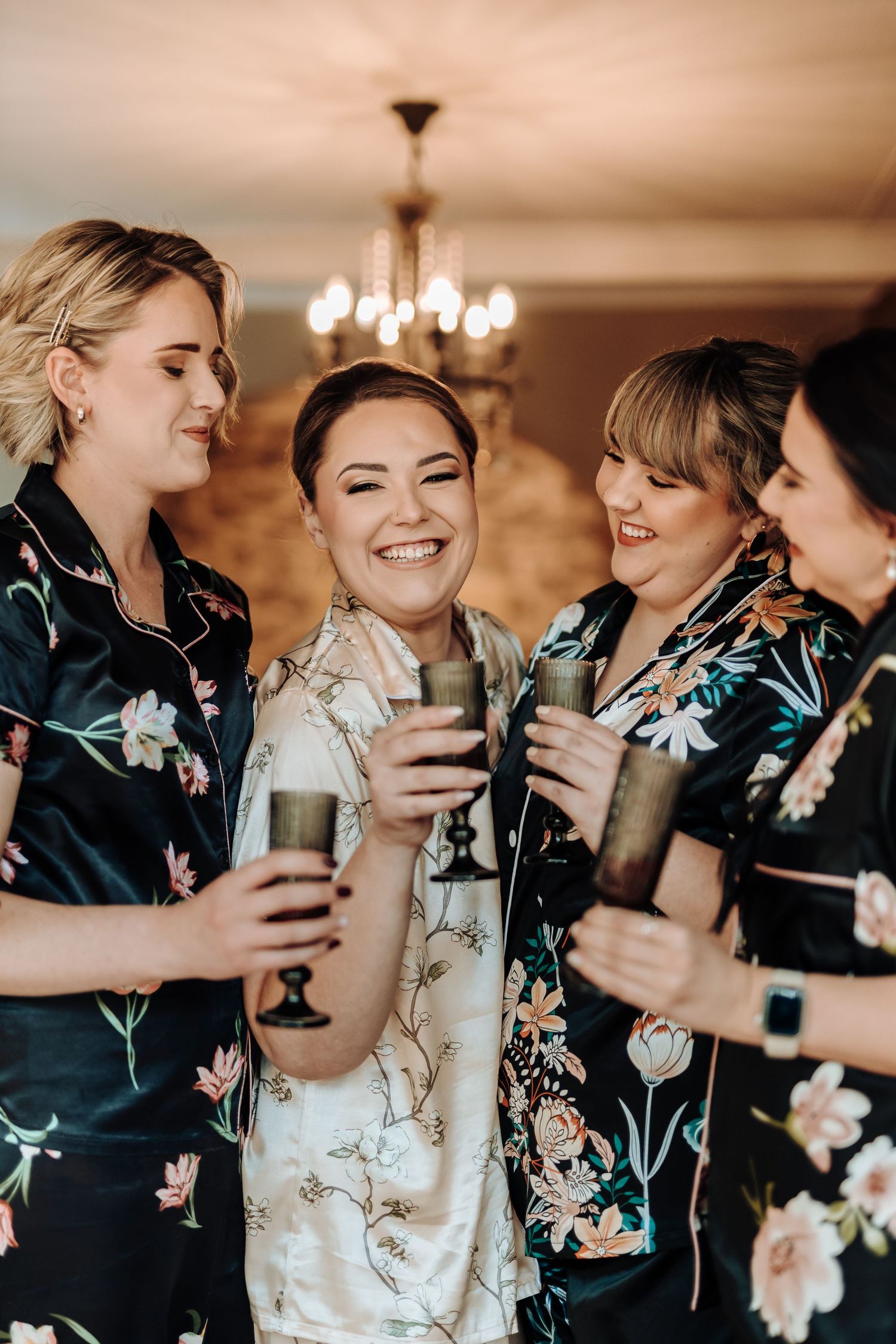 A group in coordinated floral robes sharing drinks and laughter.