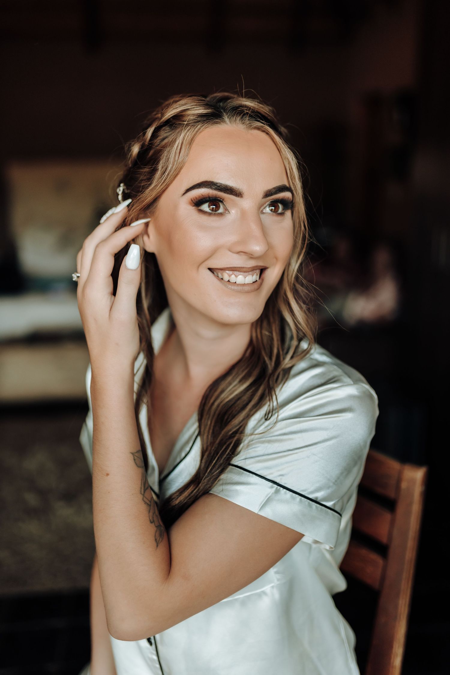 Candid portrait showing elegant styling and makeup while wearing a silky blue pajama set.